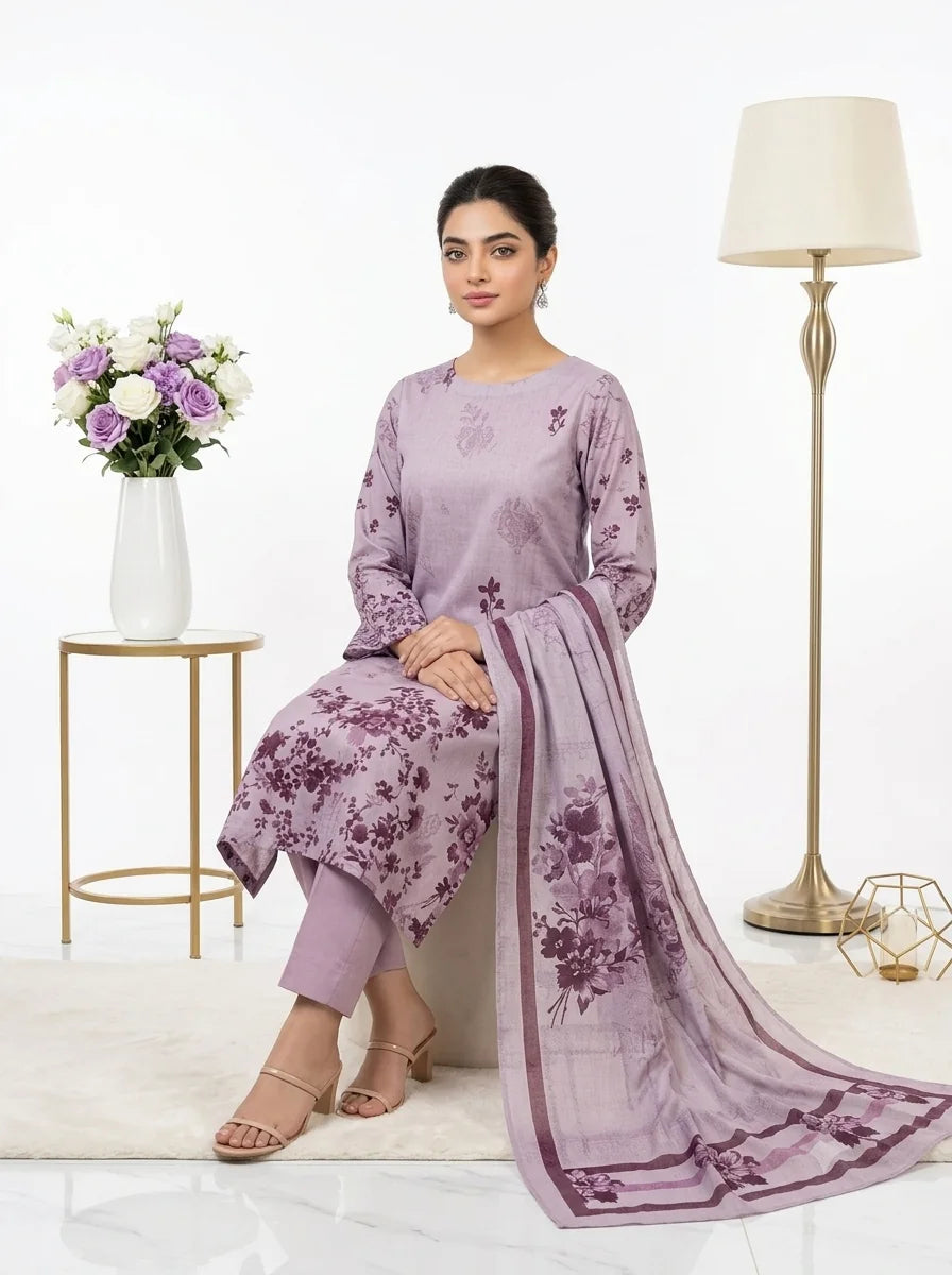 Woman in a lavender outfit with floral patterns sitting in a well-lit room.