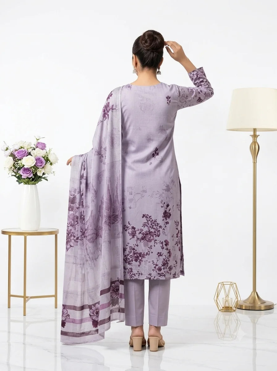 Woman wearing a light purple floral outfit with a matching dupatta in a minimalistic setting.