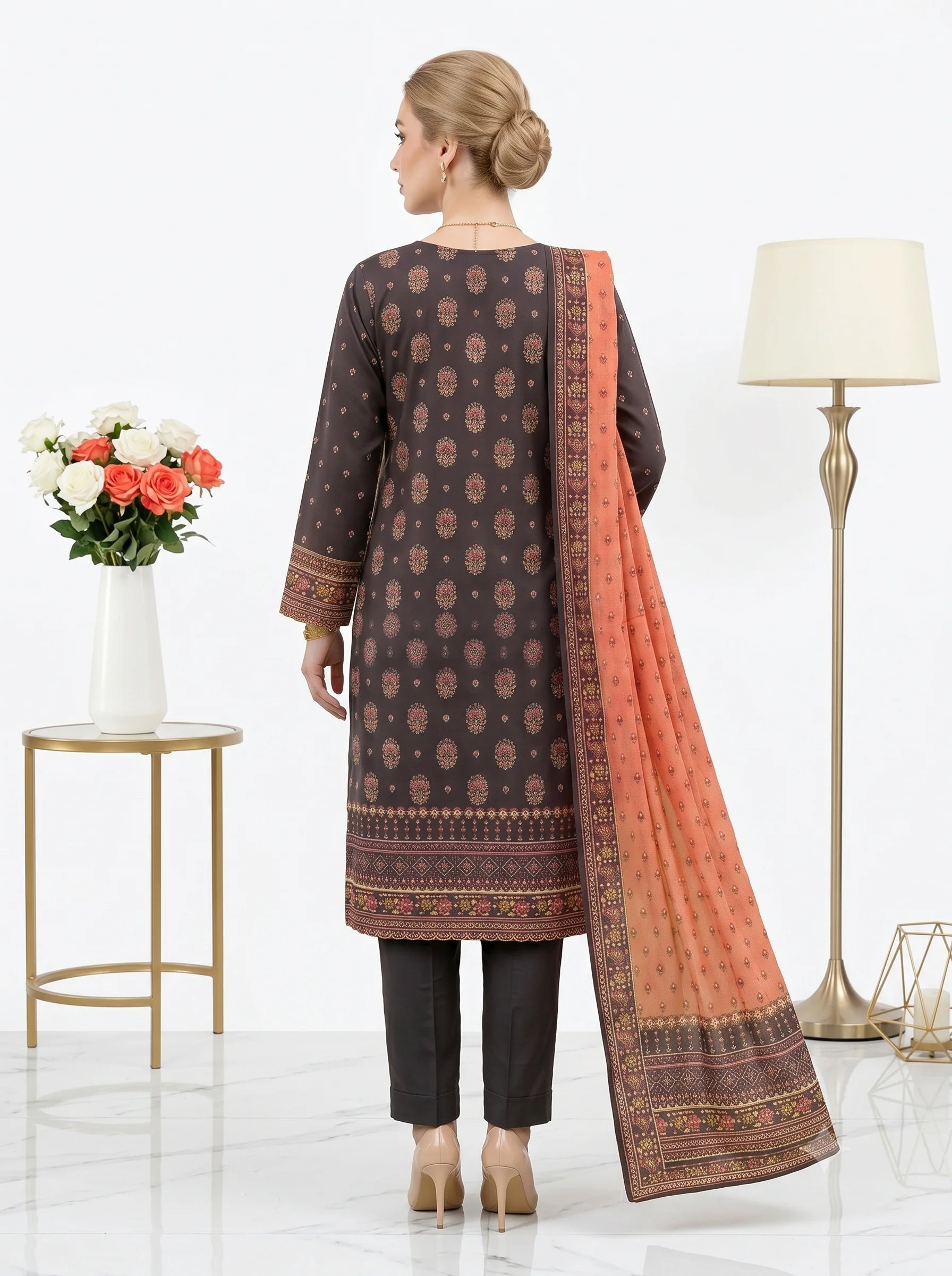 Woman wearing a traditional outfit with a patterned dupatta in a minimalistic setting.