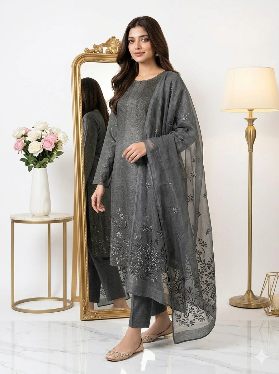 Woman wearing a gray traditional outfit with a matching dupatta in a well-lit room.