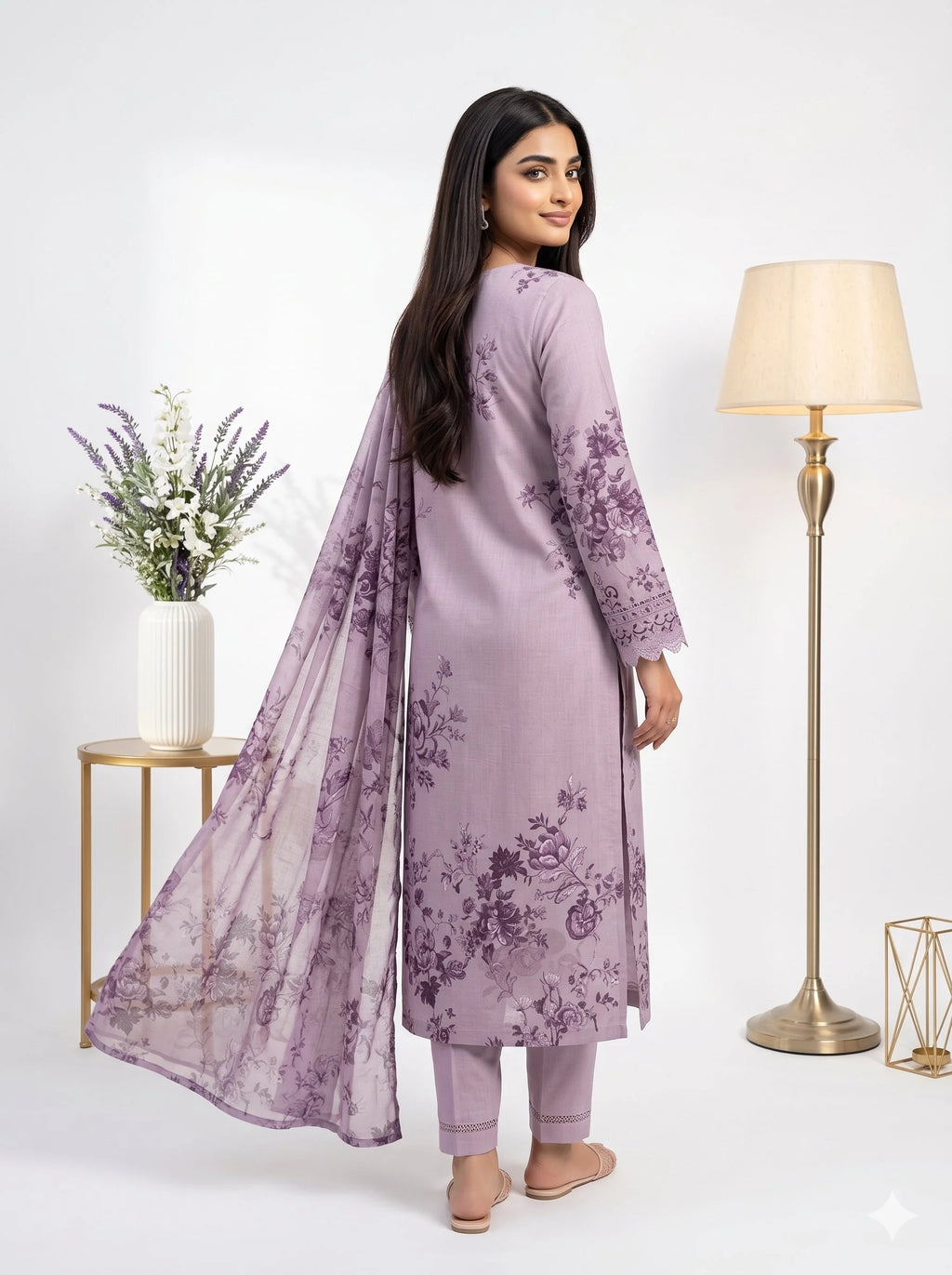 Woman wearing a lavender floral outfit with a matching dupatta on a white background