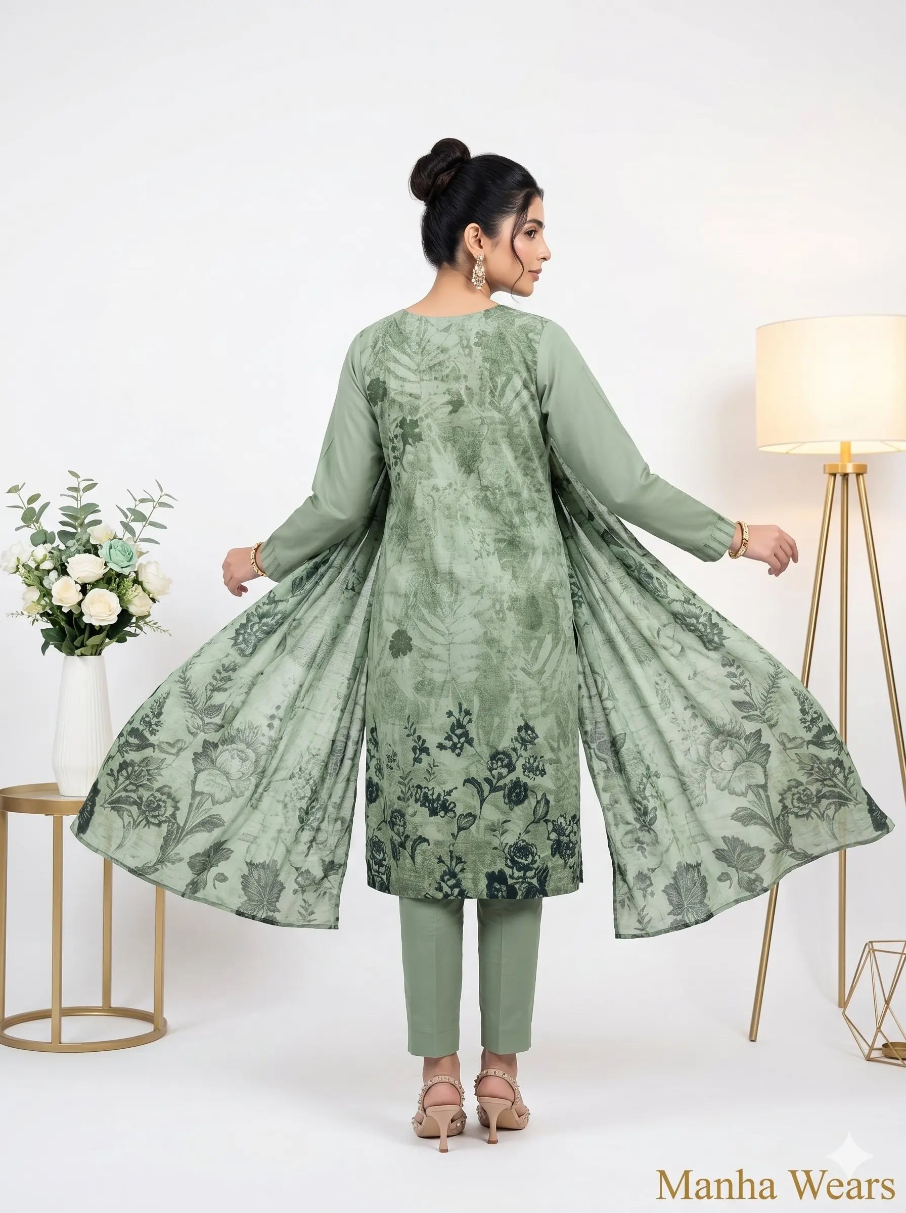Woman wearing a green floral outfit with a white background