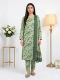 Woman wearing a green floral outfit with a matching dupatta in a well-lit room.