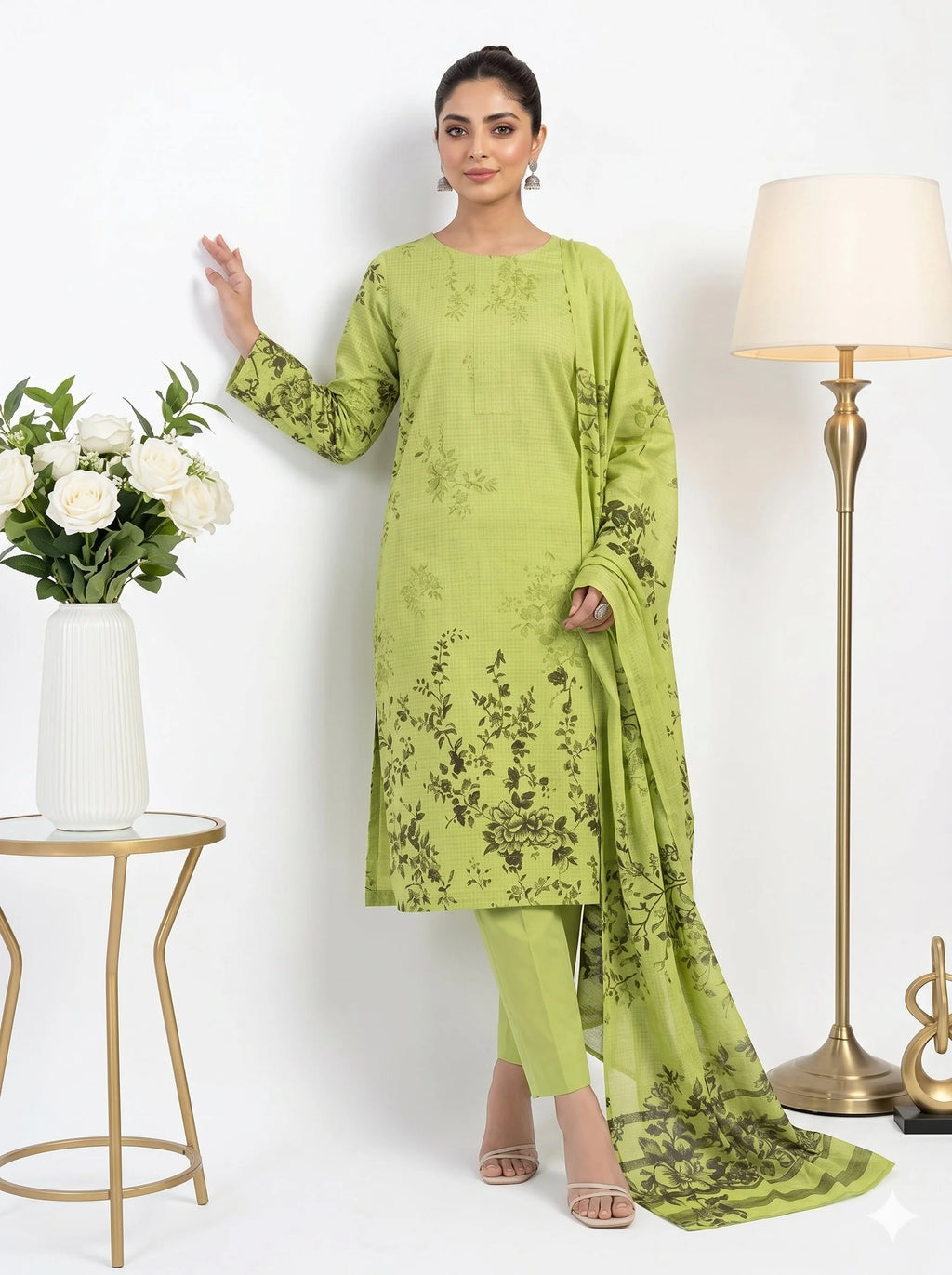 Woman wearing a green floral outfit with a white background