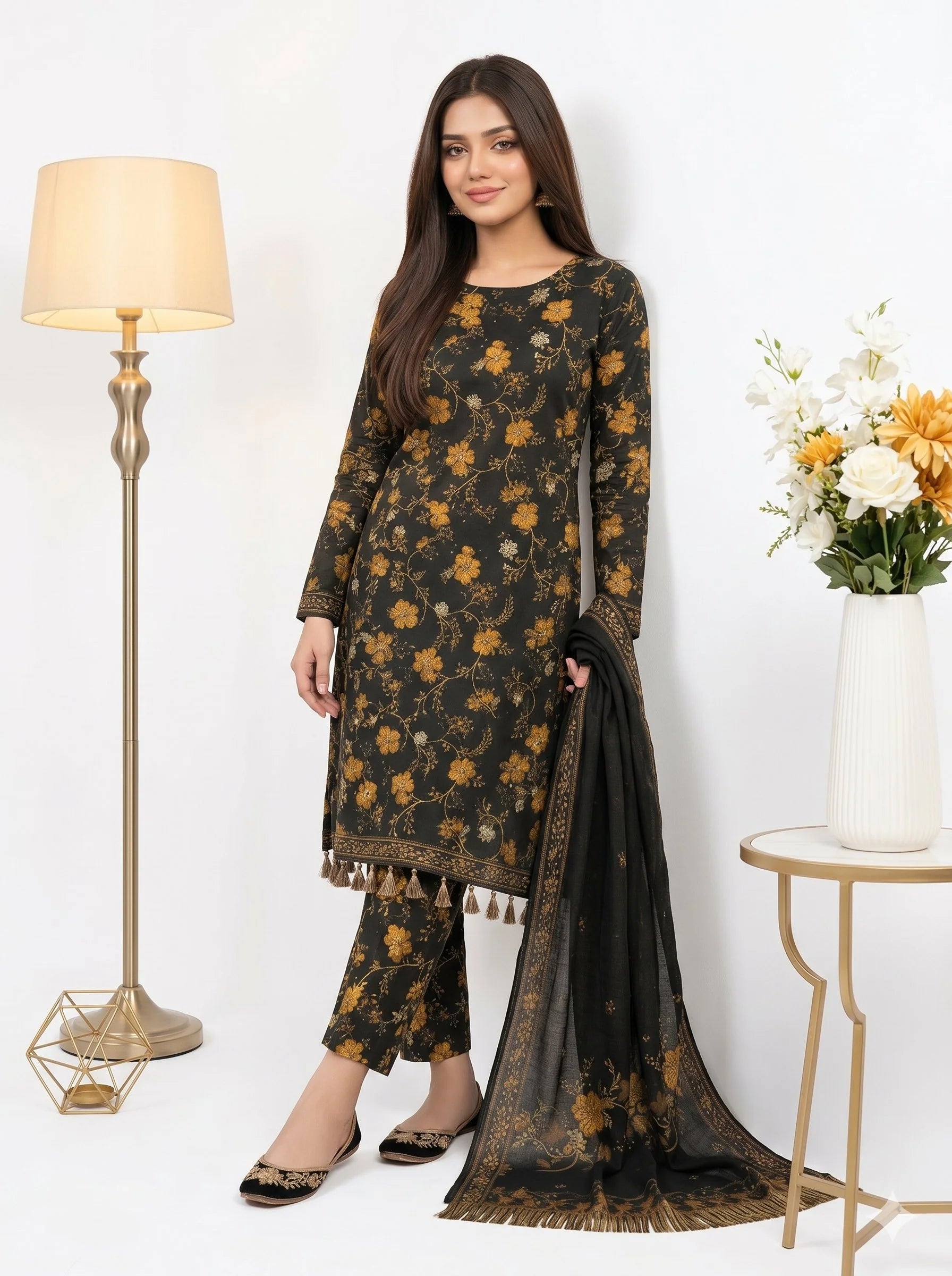 Woman wearing a floral dress with a black dupatta in a well-lit room.