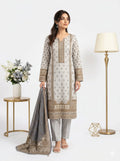 Woman wearing a traditional outfit with a matching dupatta in a minimalistic setting.