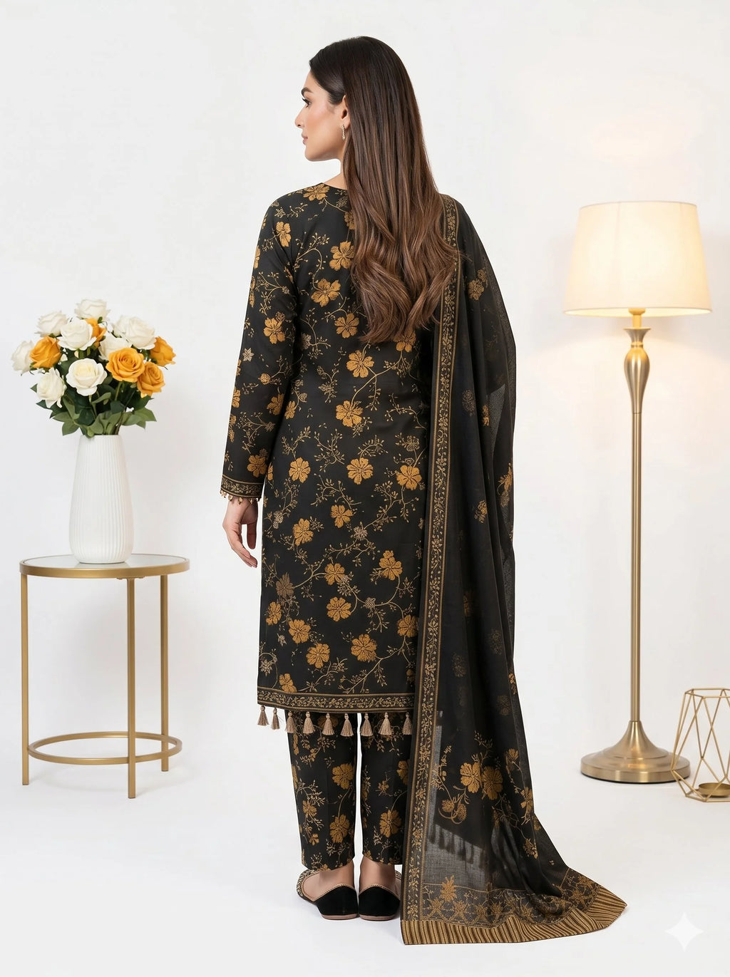 Woman wearing a black floral traditional outfit with a matching dupatta in a well-lit room.