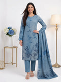 Woman wearing a blue floral outfit with a matching dupatta in a well-lit room.