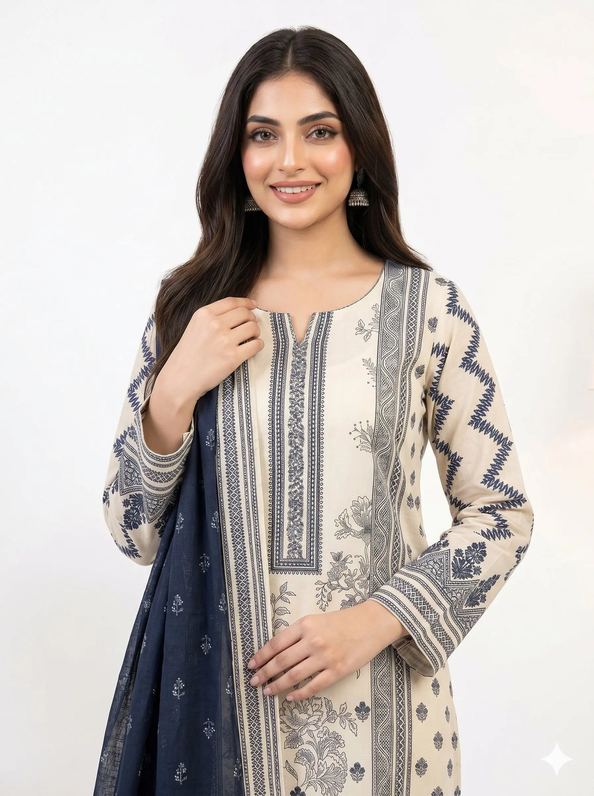 Woman wearing a patterned kurta with a navy dupatta on a white background