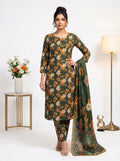 Woman wearing a green floral dress with a matching dupatta in a minimalistic setting.